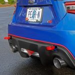 blue Subaru with two red rear-mounted tow hooks