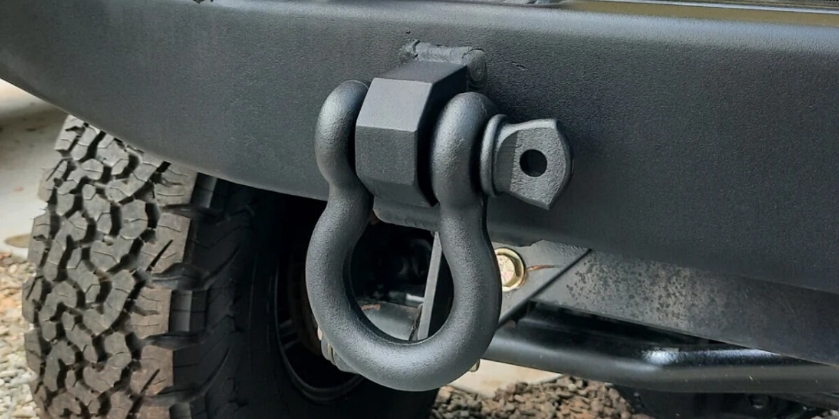 A D-shackle attached to a vehicle equipped with a strong off-road bumper