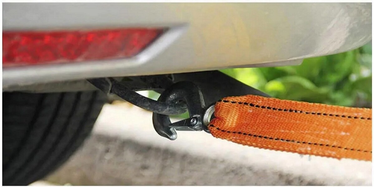 How to attach a tow hook with strap to a vehicle