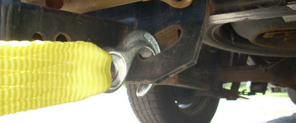 tow hook with a strap attached to the vehicle from underneath